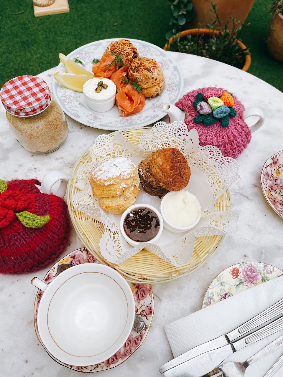 Fresh scones, tea, jam, cream, and knitted tea cosies at The Tea Cosy